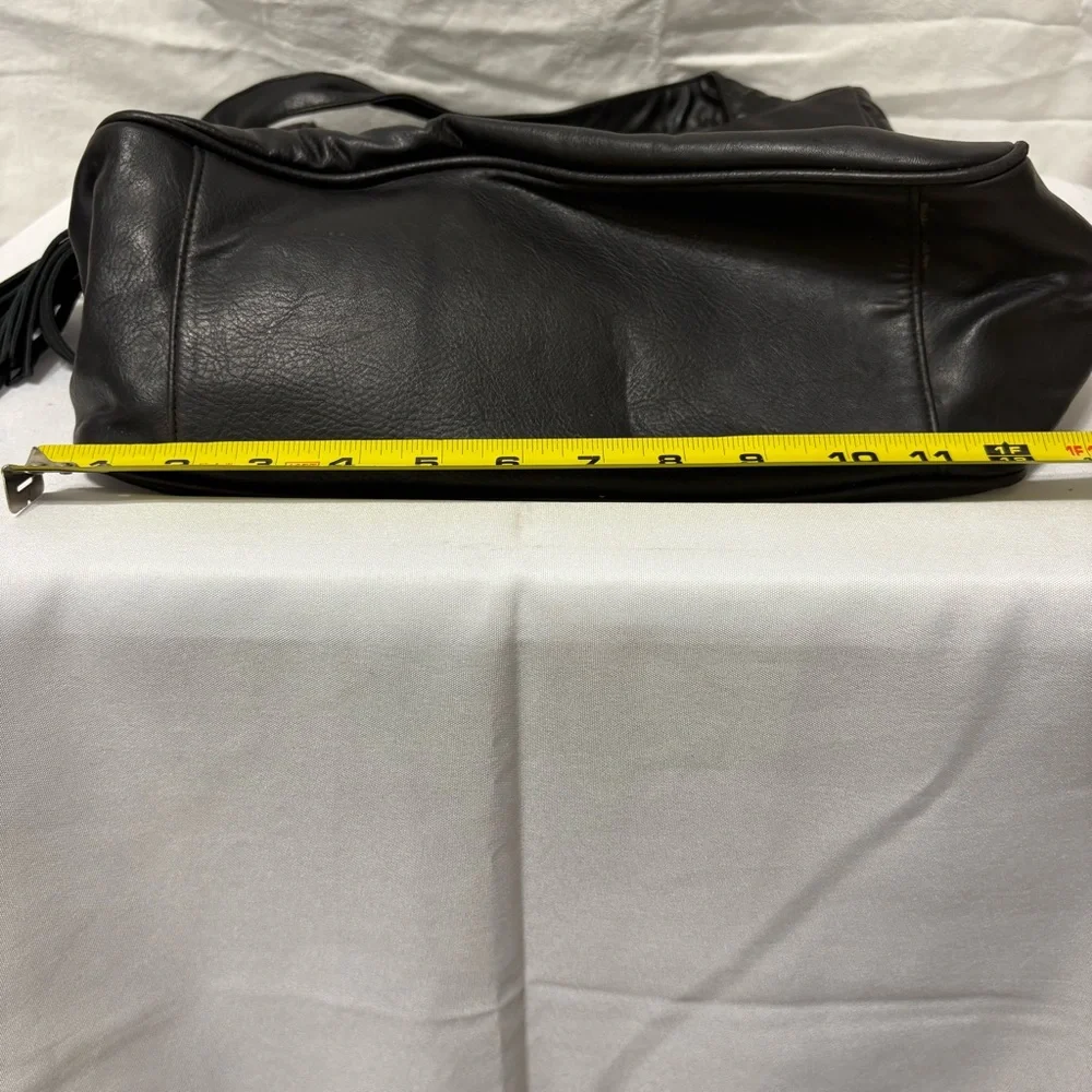 Black tote bag with a tassel accent. - Picture 9 of 12